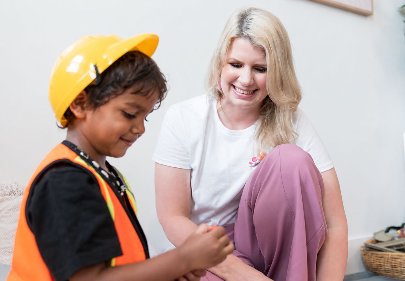 A practitioner sitting with a young child at play